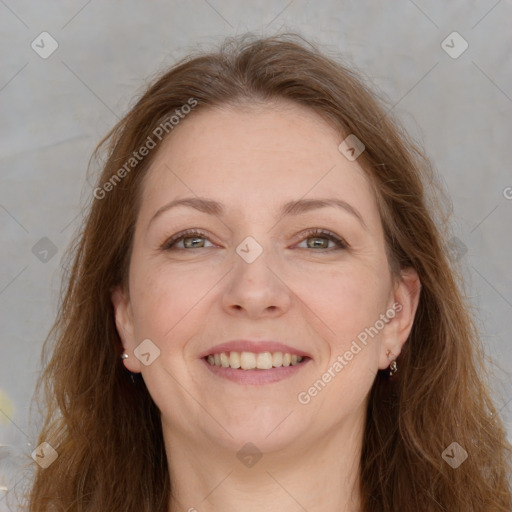 Joyful white adult female with long  brown hair and grey eyes