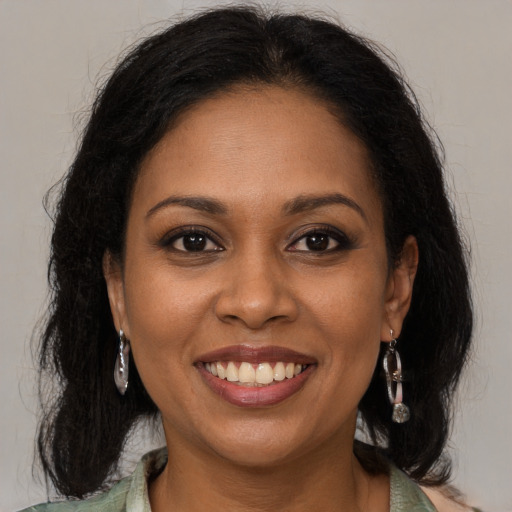 Joyful black young-adult female with medium  brown hair and brown eyes