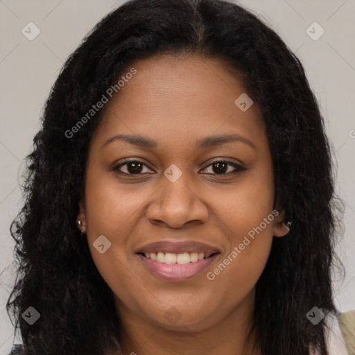 Joyful black young-adult female with long  brown hair and brown eyes