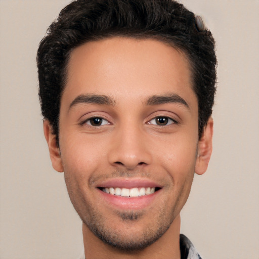 Joyful white young-adult male with short  black hair and brown eyes