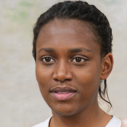 Joyful black young-adult female with short  brown hair and brown eyes