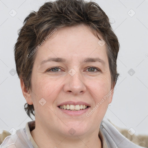 Joyful white adult female with short  brown hair and grey eyes