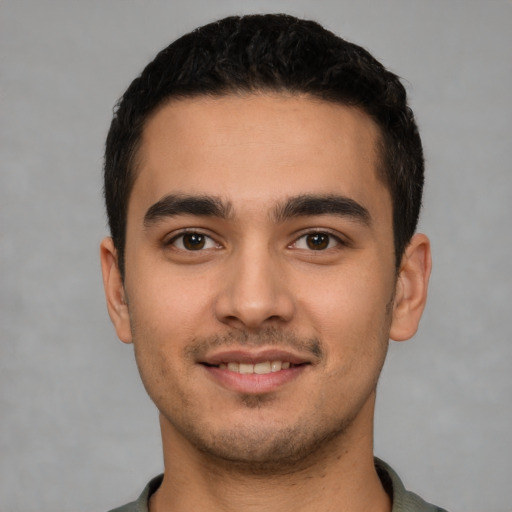 Joyful white young-adult male with short  black hair and brown eyes