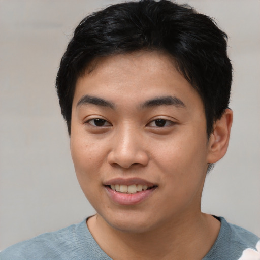 Joyful asian young-adult male with short  black hair and brown eyes
