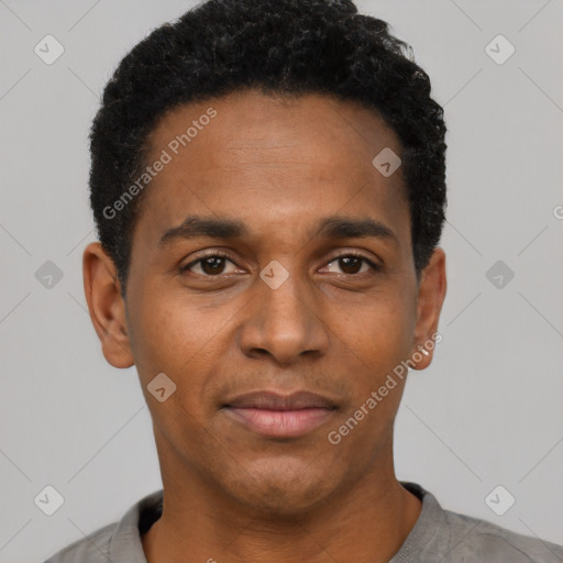 Joyful black young-adult male with short  black hair and brown eyes