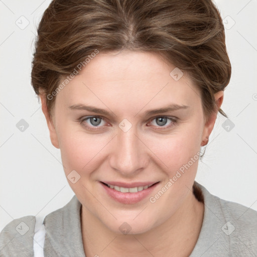 Joyful white young-adult female with short  brown hair and blue eyes