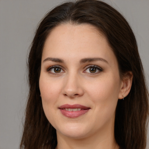 Joyful white young-adult female with long  brown hair and brown eyes