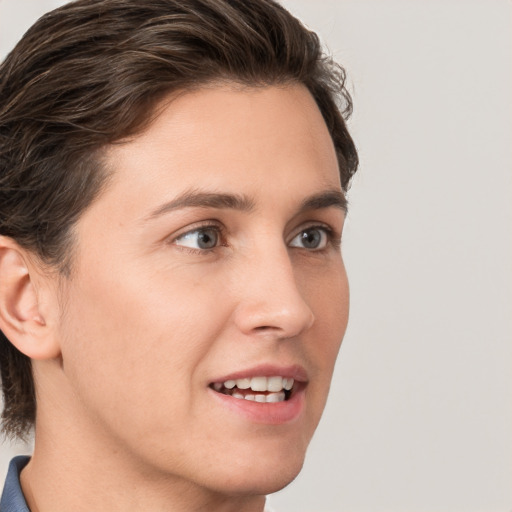 Joyful white young-adult male with medium  brown hair and grey eyes