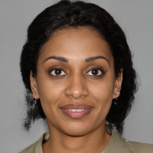 Joyful black young-adult female with medium  black hair and brown eyes