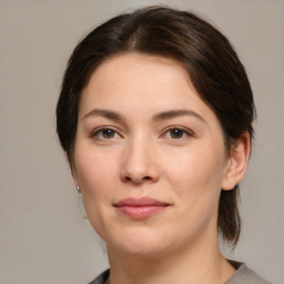 Joyful white young-adult female with medium  brown hair and brown eyes