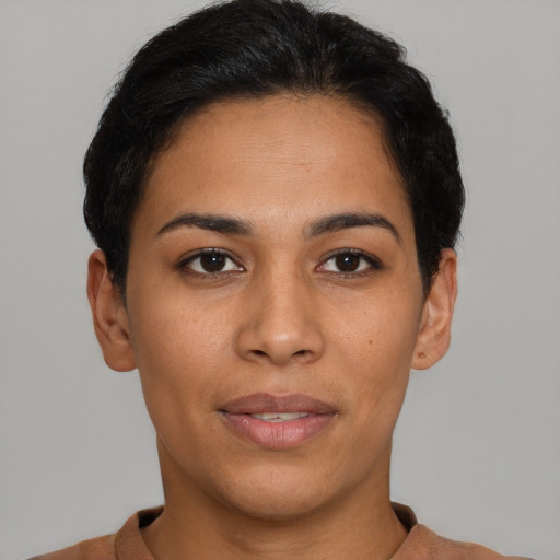 Joyful latino young-adult female with short  brown hair and brown eyes