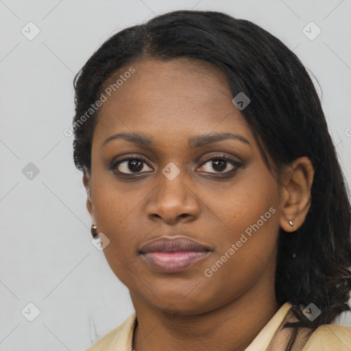 Joyful black young-adult female with long  black hair and brown eyes