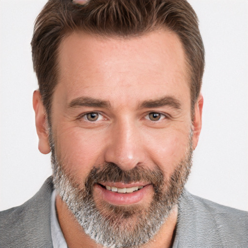 Joyful white adult male with short  brown hair and grey eyes