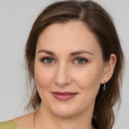 Joyful white young-adult female with medium  brown hair and grey eyes