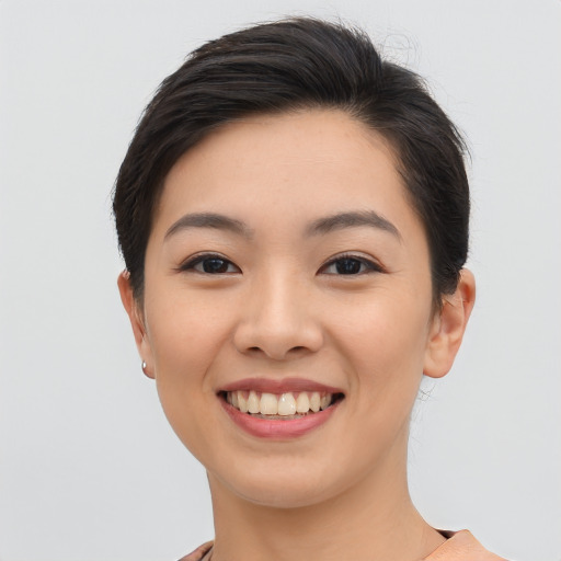 Joyful asian young-adult female with short  brown hair and brown eyes