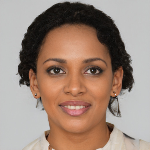 Joyful black young-adult female with medium  brown hair and brown eyes