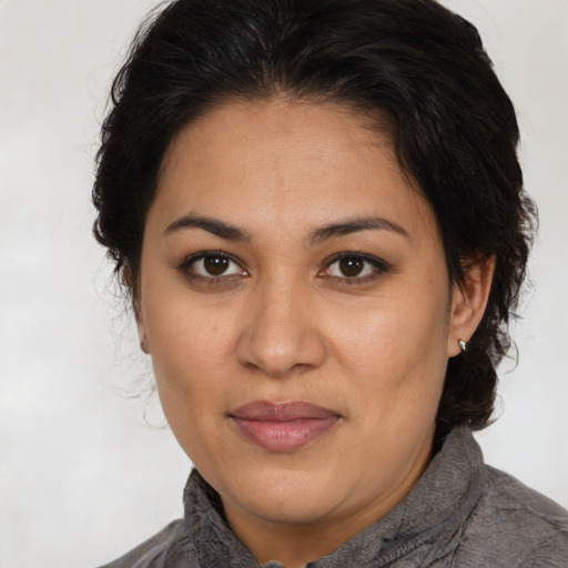 Joyful latino adult female with medium  brown hair and brown eyes