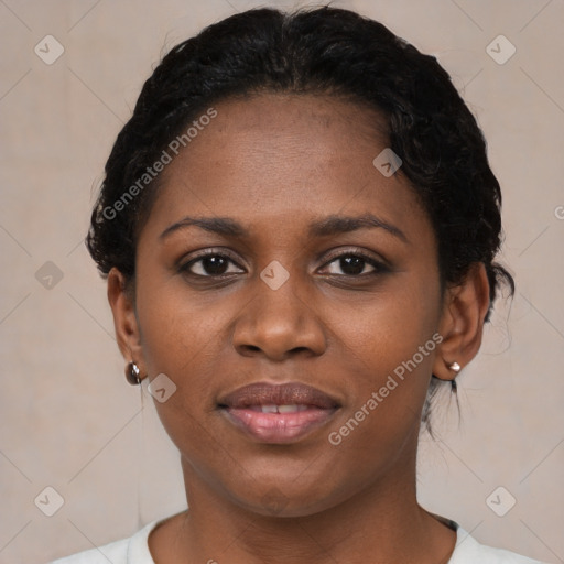 Joyful black young-adult female with short  black hair and brown eyes