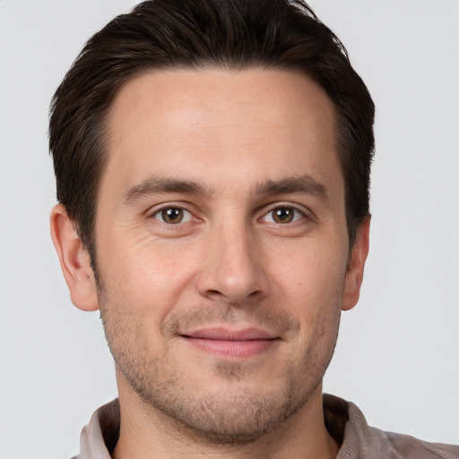 Joyful white young-adult male with short  brown hair and brown eyes