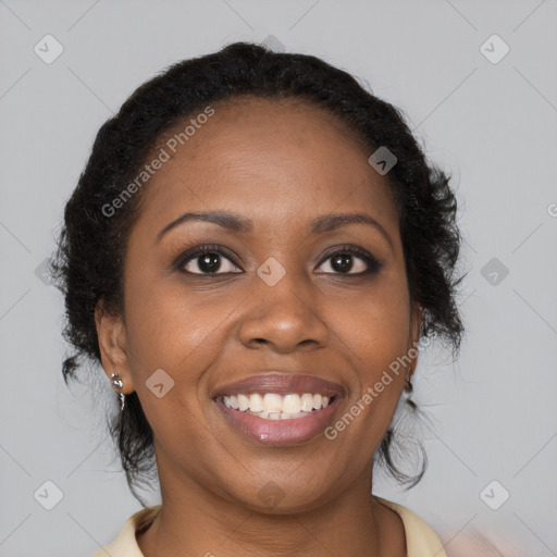 Joyful black young-adult female with long  brown hair and brown eyes