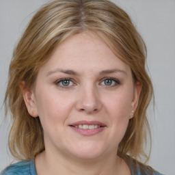 Joyful white young-adult female with medium  brown hair and blue eyes