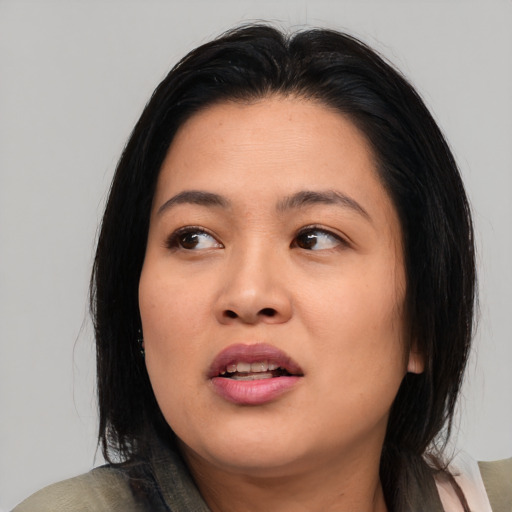 Joyful asian young-adult female with medium  black hair and brown eyes