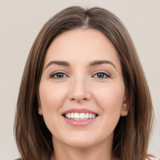 Joyful white young-adult female with long  brown hair and brown eyes