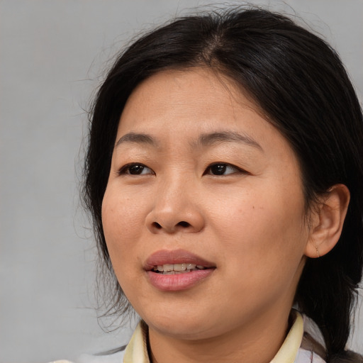 Joyful asian young-adult female with medium  brown hair and brown eyes
