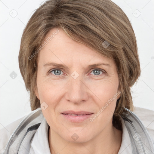 Joyful white adult female with medium  brown hair and grey eyes