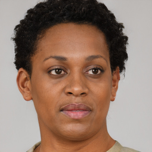 Joyful black adult female with short  brown hair and brown eyes
