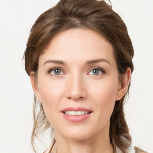 Joyful white young-adult female with medium  brown hair and grey eyes