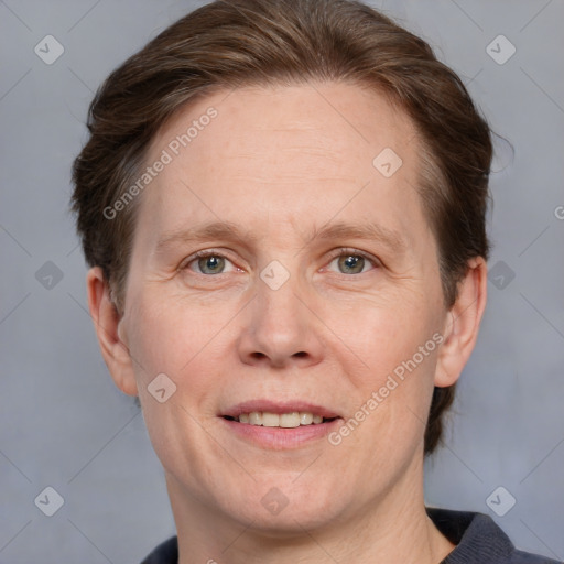 Joyful white adult female with short  brown hair and grey eyes