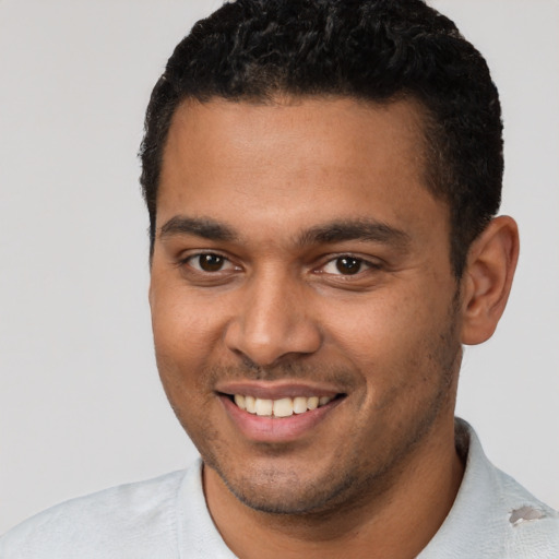 Joyful latino young-adult male with short  brown hair and brown eyes
