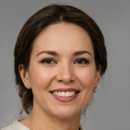 Joyful white young-adult female with medium  brown hair and brown eyes