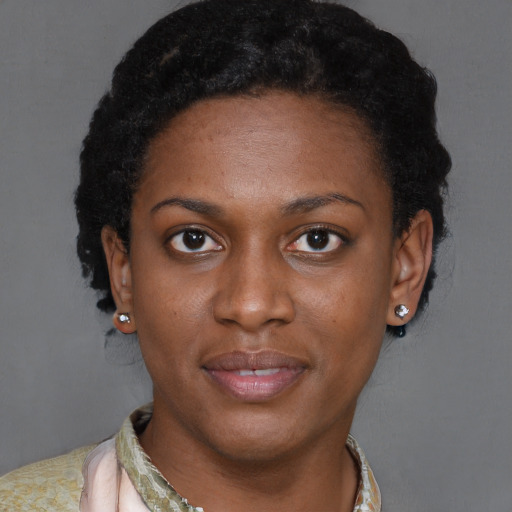 Joyful black young-adult female with short  brown hair and brown eyes