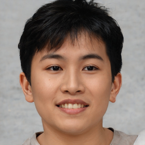 Joyful asian young-adult male with short  brown hair and brown eyes