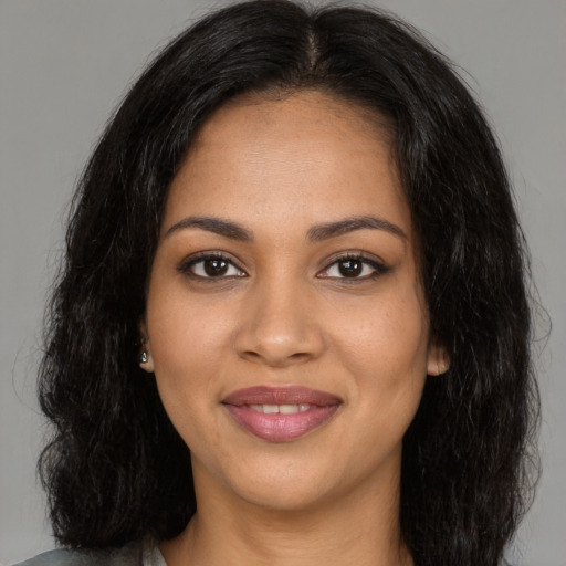 Joyful latino young-adult female with long  black hair and brown eyes