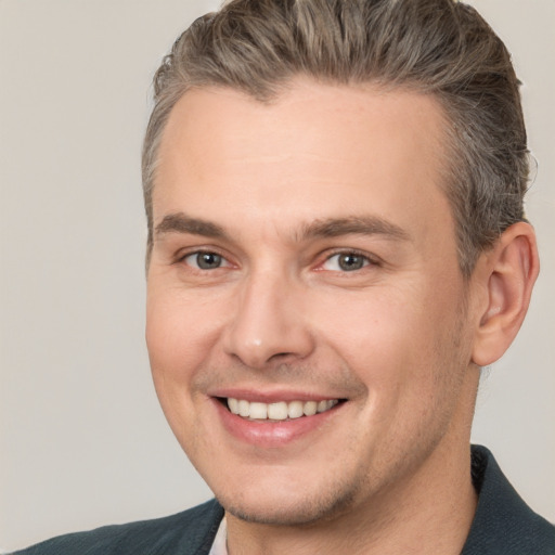 Joyful white adult male with short  brown hair and brown eyes