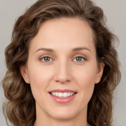 Joyful white young-adult female with medium  brown hair and green eyes