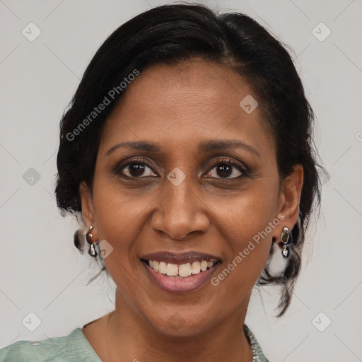 Joyful black adult female with medium  brown hair and brown eyes