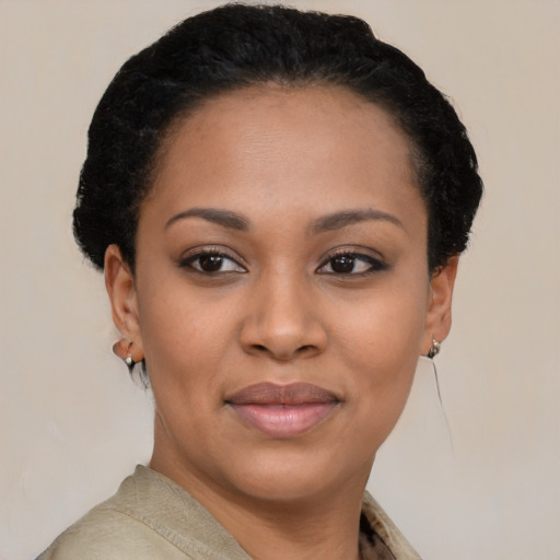 Joyful black young-adult female with short  black hair and brown eyes