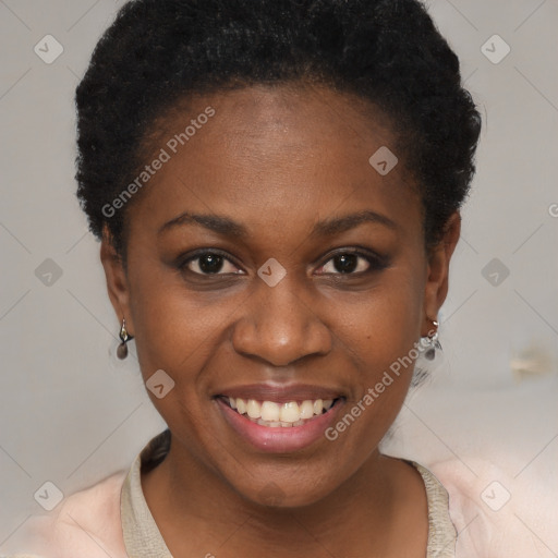 Joyful black young-adult female with short  black hair and brown eyes