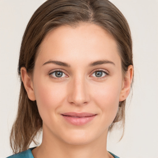 Joyful white young-adult female with medium  brown hair and grey eyes