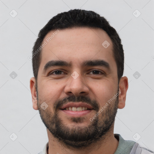 Joyful white young-adult male with short  black hair and brown eyes