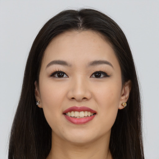 Joyful asian young-adult female with long  brown hair and brown eyes