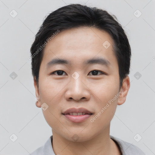 Joyful asian young-adult male with short  black hair and brown eyes