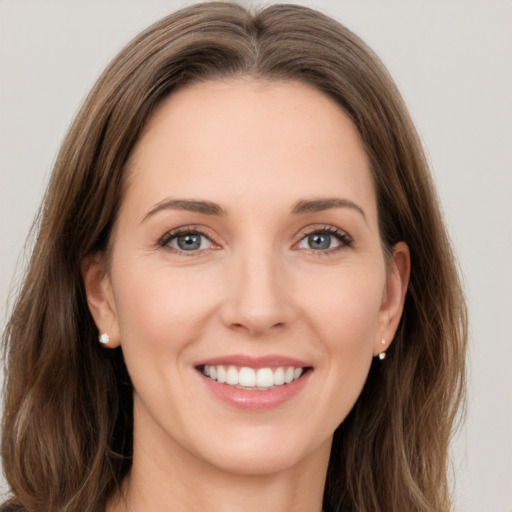 Joyful white young-adult female with long  brown hair and green eyes