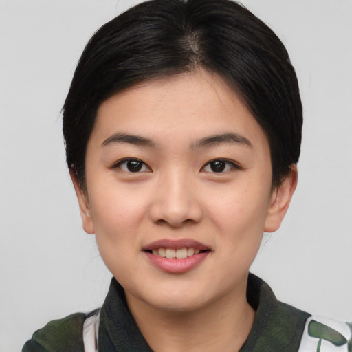 Joyful white young-adult female with short  black hair and brown eyes