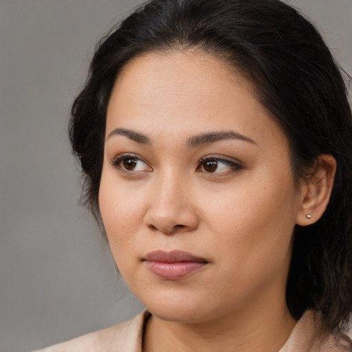 Joyful asian young-adult female with long  brown hair and brown eyes