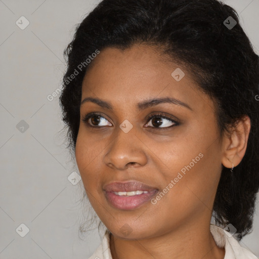 Joyful black young-adult female with medium  brown hair and brown eyes